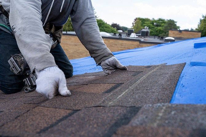 Cost of Roof Replacement in California. Image of close up of asphalt shingles being laid.
