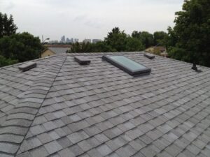 Cost of Roof Replacement in California. Image of freshly replaced roof with skylight.