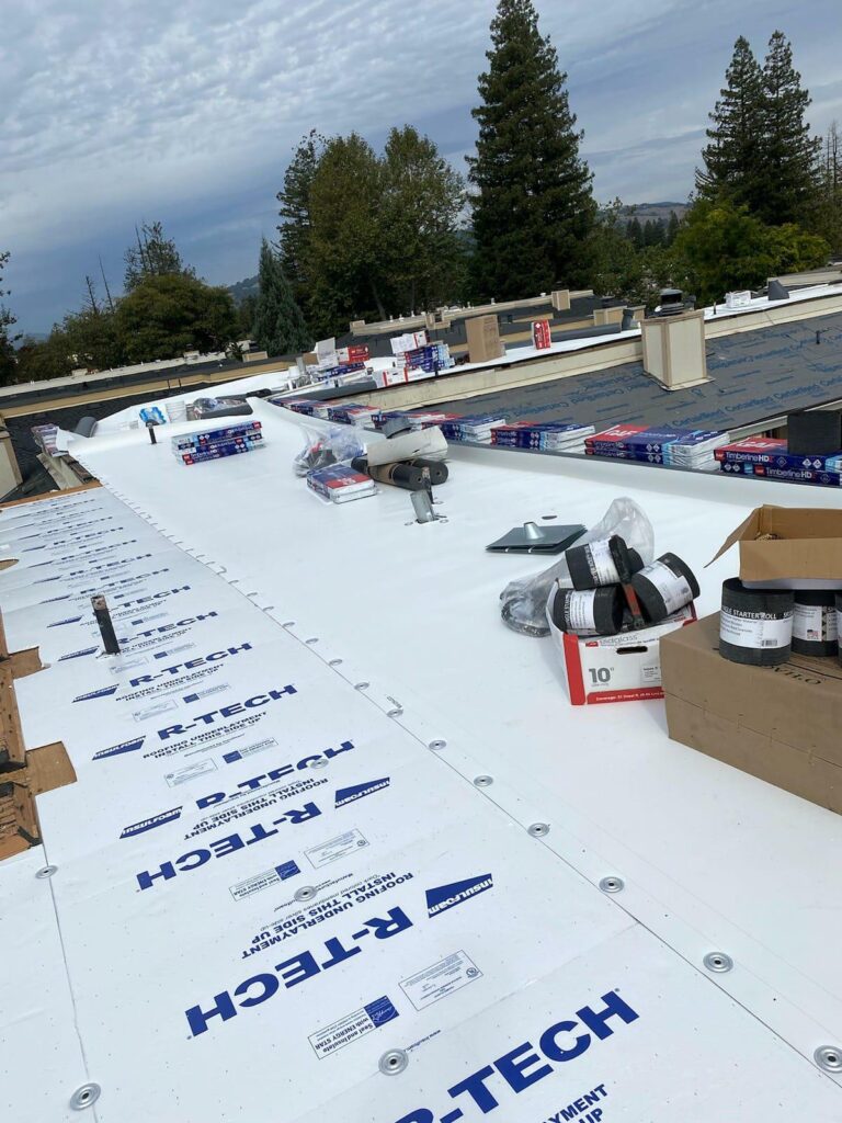 roofing materials list. Image of laid out and stacked roofing materials on a roof.