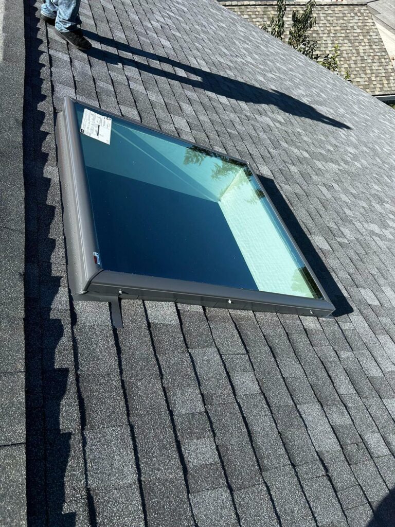 roofing materials list. Picture of flashing around a skylight on a roof that has just been replaced.
